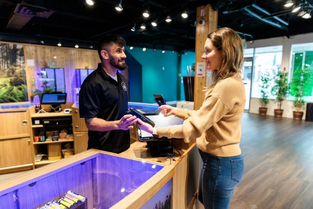 A visitor asking questions at the counter of a licensed dispensary