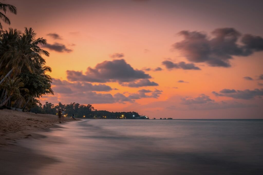Sunset over a palm-lined beach on Koh Samui, Thailand